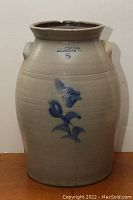 Full front view of the crock showing floral design, color, and markings.