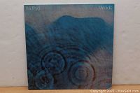 Front cover of Pink Floyd Meddle vinyl album showing blue water ripple abstract design with text 'Pink Floyd' and 'Meddle'.