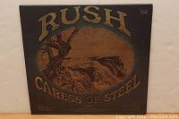 Front of the Rush Caress of Steel album cover with title and artwork.
