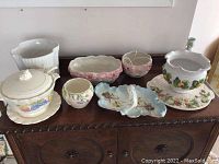 Photo showing all ceramic items from a frontal angle on wooden surface