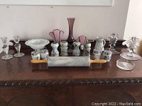 Full view of lot showing marble rolling pin, salt and pepper shakers, Royal Worcester containers, glass vases, bowls, and candlestick holders on wooden surface