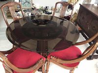 Overall view of round glass top table with four chairs