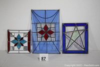 Front view of three stained glass panels with star patterns on a white background showing size and color.