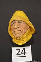 Close-up image of the lifeboatman wall hanging sculpture showing detailed facial features and yellow rain gear.