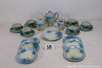 Full tea set including teapot, sugar bowl, creamer, 6 cups with saucers, 1 luncheon plate, and 6 dessert plates all displayed on a flat surface.