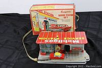 Front view of Mobilgas service station set with original box behind showing overall condition and packaging artwork