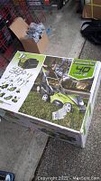 Box top showing Greenworks 40V lawn mower image and branding