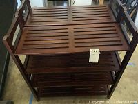 Two wooden slatted shelf units shown stacked or side by side, medium brown finish, four tiers each.