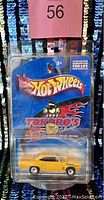 Front view of original Hot Wheels packaging showing yellow 1990 Plymouth Roadrunner die-cast car from 2002 Tokoro's Collection special edition.