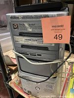 HP Pavilion desktop computer tower front view with spec labels and cables