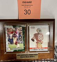Full view of plaque showing both Joe Montana and Jerry Rice cards behind clear acrylic with plaque label below.