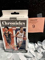 Front view of the sealed 2021 Panini Chronicles Draft Picks basketball trading card hanger box, showing players Cade Cunningham and Jalen Suggs on front, and the number of cards (30)