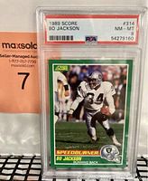 Photo of the front of the 1989 Score Bo Jackson football card in PSA graded slab showing grade NM-MT 8.