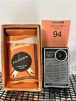 Lloyds TR 6P transistor radio in original box with guarantee paper visible under orange sleeve.