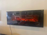 Front view of electric fireplace with flame effect active