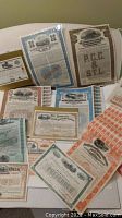 Overview of multiple railway bond certificates with attached coupons