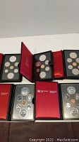 Five original proof set display cases open showing all coins