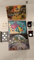 Overview photo of multiple Canadian coin sets including three 25-cent sets and other coin sets with illustrated backgrounds