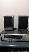 Technics SA-225 receiver front panel with two Bose bookshelf speakers on top