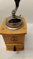 Wooden coffee grinder with metal crank and black knob, Armin Grosser branded