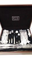 Wexford Forge 84-piece stainless steel flatware set in a wooden box, showing forks, spoons, knives wrapped in plastic.