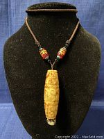 Photo of the full necklace on a black display bust showing the length and overall look.