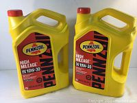 Two yellow plastic containers of Pennzoil High Mileage SAE 10W-30 motor oil, side by side showing front labels.