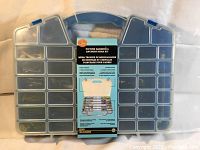 Closed clear plastic carrying case with blue handle and blue locking clasps, containing 364 pieces kit.