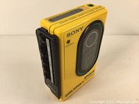 Angled front and side view showing yellow housing and black control panel