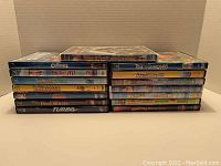 View of the two stacks of DVD cases showing titles of Dreamworks movies included in the lot.