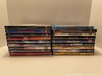 Front stacked photo showing all 18 Disney and Disney Pixar movies in DVD cases, titles visible.