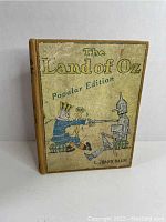 Front cover showing title and color illustration of Scarecrow and Tin Woodman