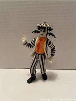 Front view of the 1989 Kenner Beetlejuice action figure with parasol hat and bats.