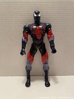 Front view of the Spider-Man Miles Morales action figure showing the black and red costume with large red spider emblem on the chest.