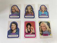 Six sticker cards of Three's Company characters shown front side with colorful portrait cutout design and text.