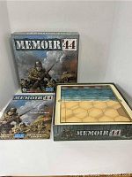 Game box cover, board and rulebook laid out