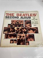 Front cover of The Beatles' Second Album vinyl record showing text and multiple black-and-white photos of the band.