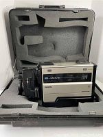 Vintage Philips VHS camcorder in beige and black plastic with foam lined hard carrying case.