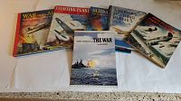 Six vintage books displayed on white background showing covers and titles with military and aviation themes from 1940s, visible wear and usage marks.