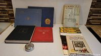 Displayed all items including UBC annuals, McGill yearbooks, Mayo Clinic books and brochures, and the pewter trinket case.