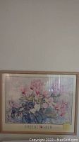 Framed wall art with pink flowers labeled 'PHOEBE'.