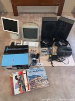Full lot arranged including two iMac computers, speakers, cassette tapes, cables, turntable box, and vinyl records.