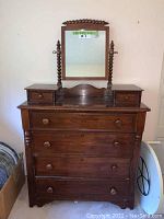 Front view of solid wood vintage dressing table with mirror and drawers.