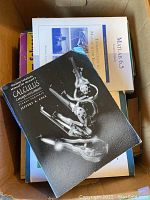 Top view inside box shows student solutions manual for calculus by Jeffery A. Cole and MATLAB 6.5 book along with other textbooks in the lot, all used condition.