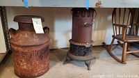 Photo showing the metal milk can, the rusty Perfection oil heater, and the wooden rocking chair in the background on the right.
