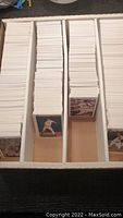 Multiple stacks of 1991 Upper Deck baseball cards stored upright in white sorting boxes, showing card fronts with player images and details.