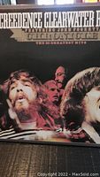 Front cover of Creedence Clearwater Revival vinyl album titled 'Chronicle: The 20 Greatest Hits' featuring John Fogerty with band photo.