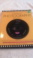Front cover of the Reader's Digest Complete Photography Manual, showing the title and camera lens image.