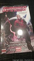 Front cover of the sealed Guardians of the Galaxy Through the Looking Glass graphic novel showing key characters and title.