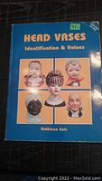 Front cover of the softcover book titled 'Head Vases Identification & Values' by Kathleen Cole, showing six different head vase images on a blue background.